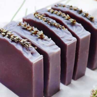 Five lavender color lavender soap blocks stacked in a line